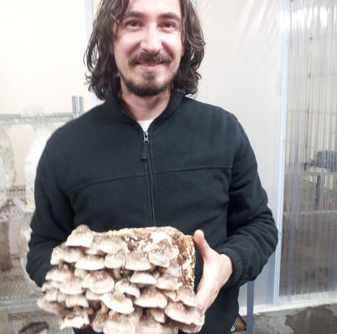 Dr Dan Tura holding a mushroom specimen